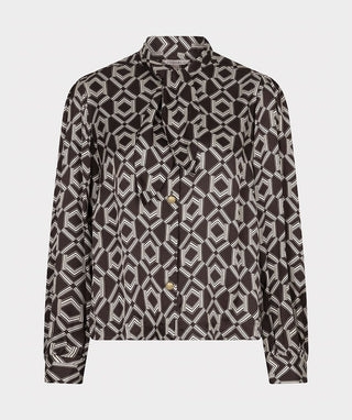 A long-sleeve button-up shirt with a geometric pattern in black and beige, featuring a tie-neck detail and gold buttons, shown against a light gray background.