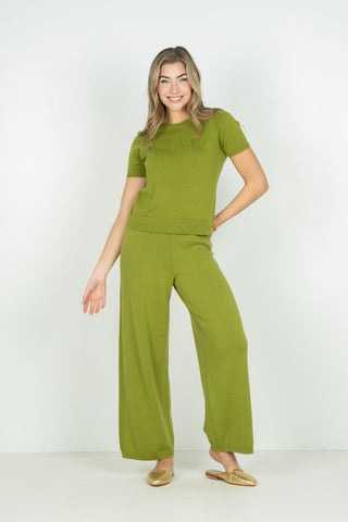 Woman wearing a green outfit on a white background