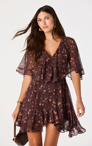 Embrace effortless elegance in this floral chiffon mini dress, designed to make a statement with every step. Featuring a rich, moody floral print on lightweight chiffon, this romantic dress offers a flattering silhouette that's perfect for both daytime events and evening occasions.

The soft V-neckline and dramatic cape sleeves create an elegant, flowing look, while the fitted natural waist enhances your shape before falling into a relaxed, above-the-knee skirt. An asymmetrical flounce hem adds graceful mov
