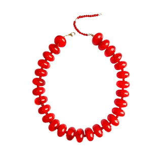 Red beaded necklace on a white background